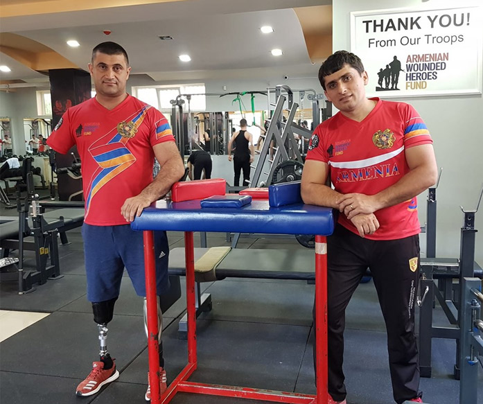 Artsakh war hero, triple amputee, arm wrestling world champion Major Sargis Stepanyan with his trainer at Legends Gym